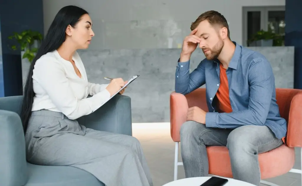A compassionate EMDR therapist Yuba City listening to a client in a safe, welcoming therapy room.